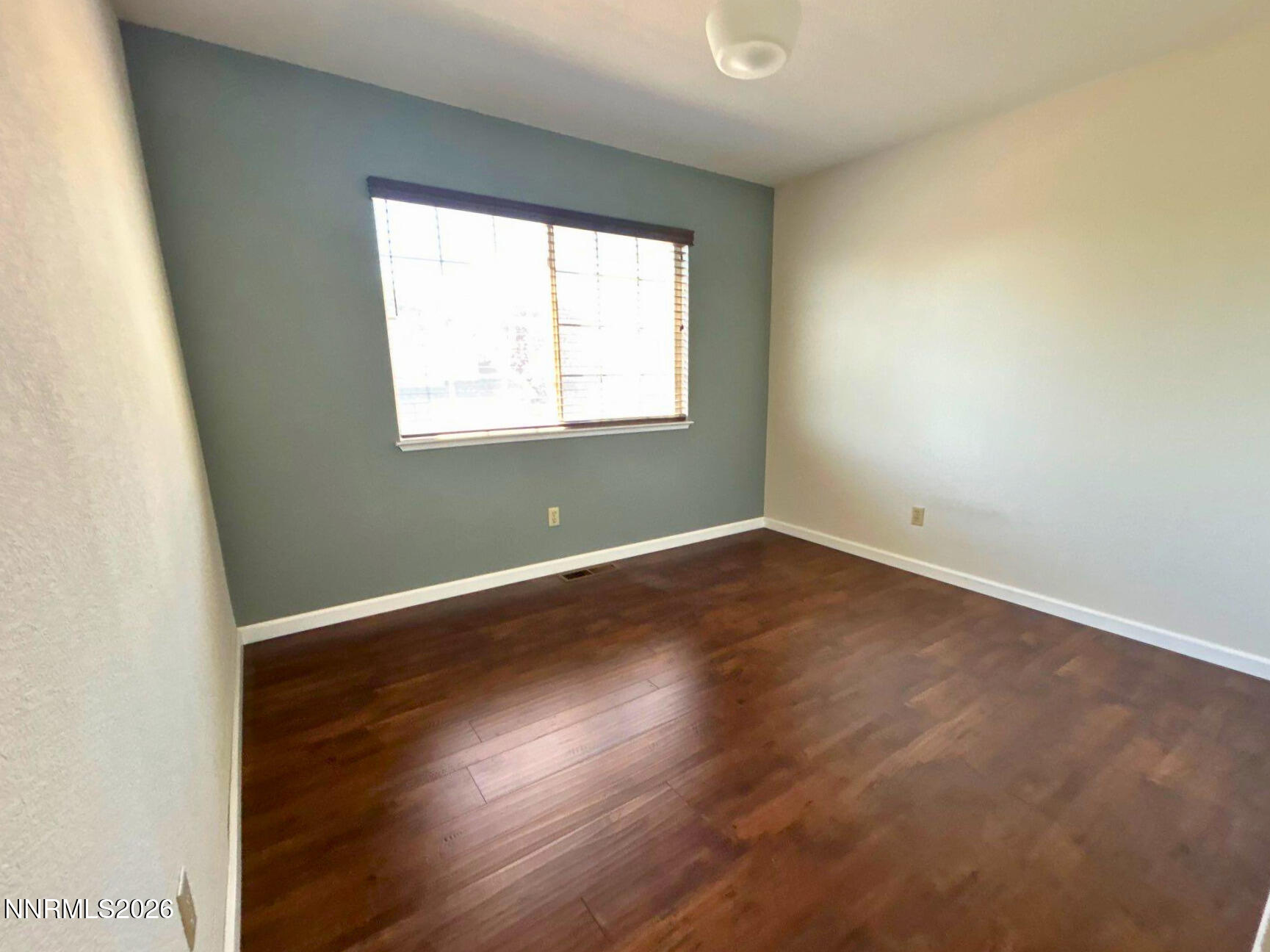 4437 Highplains Drive Reno, NV 89523 - Photo 15 of 19 an empty room with wooden floor and windows