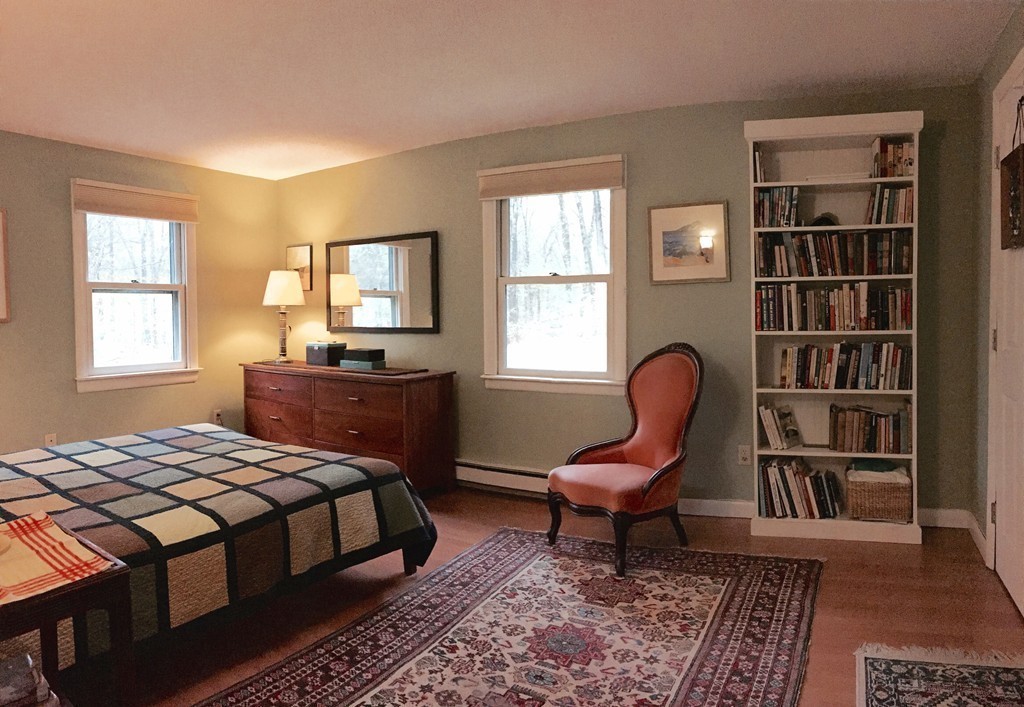 14 Gulf Road Pelham, MA 01002 - Photo 18 of 30 a bedroom with a bed a bookshelf and a window