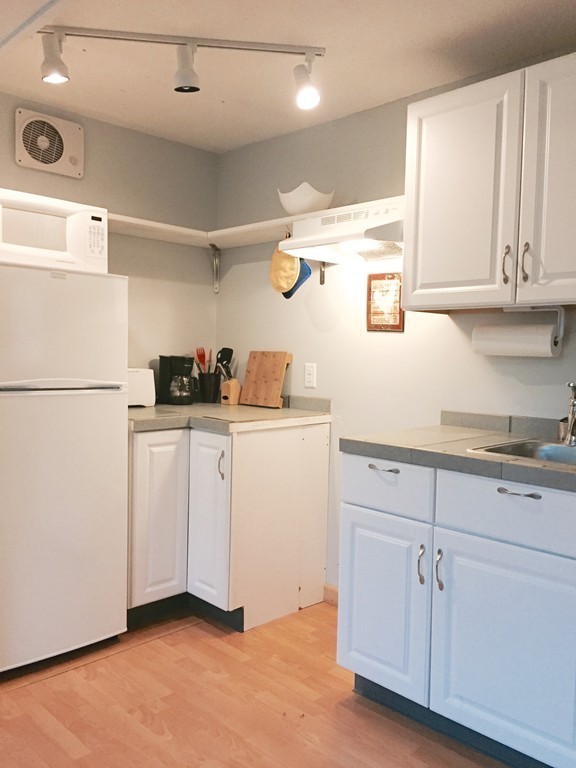 14 Gulf Road Pelham, MA 01002 - Photo 26 of 30 a kitchen with white cabinets and white appliances