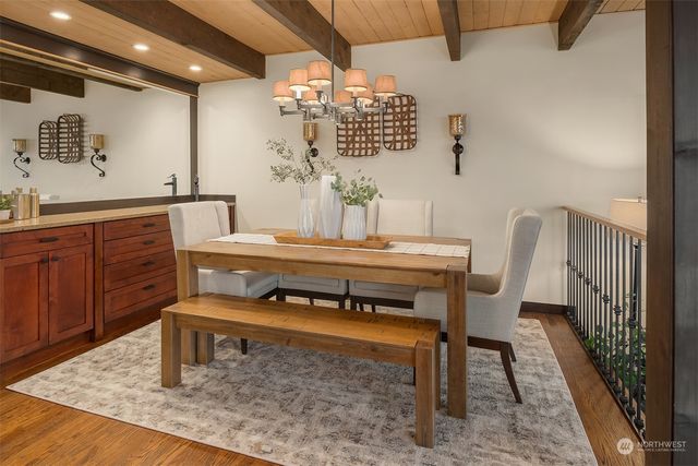 a dining room with furniture and a mirror