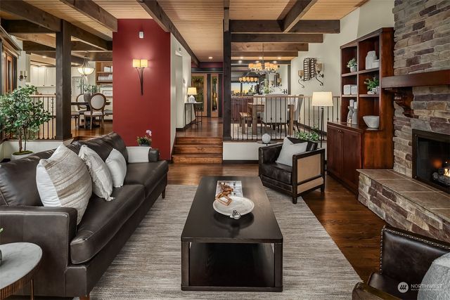 a living room with furniture a rug and a fireplace