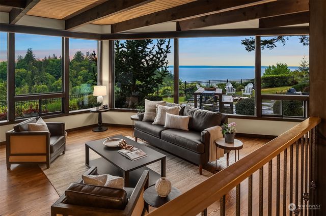 a living room with patio furniture and a potted plant