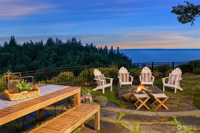 a view of a balcony with two chairs and a table