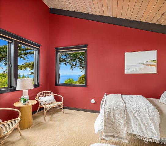 a bedroom with a bed and a chair