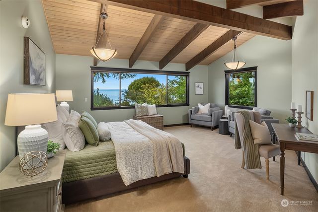 a bedroom with furniture and a large window