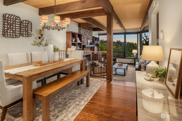 a living room with furniture a flat screen tv and a floor to ceiling window