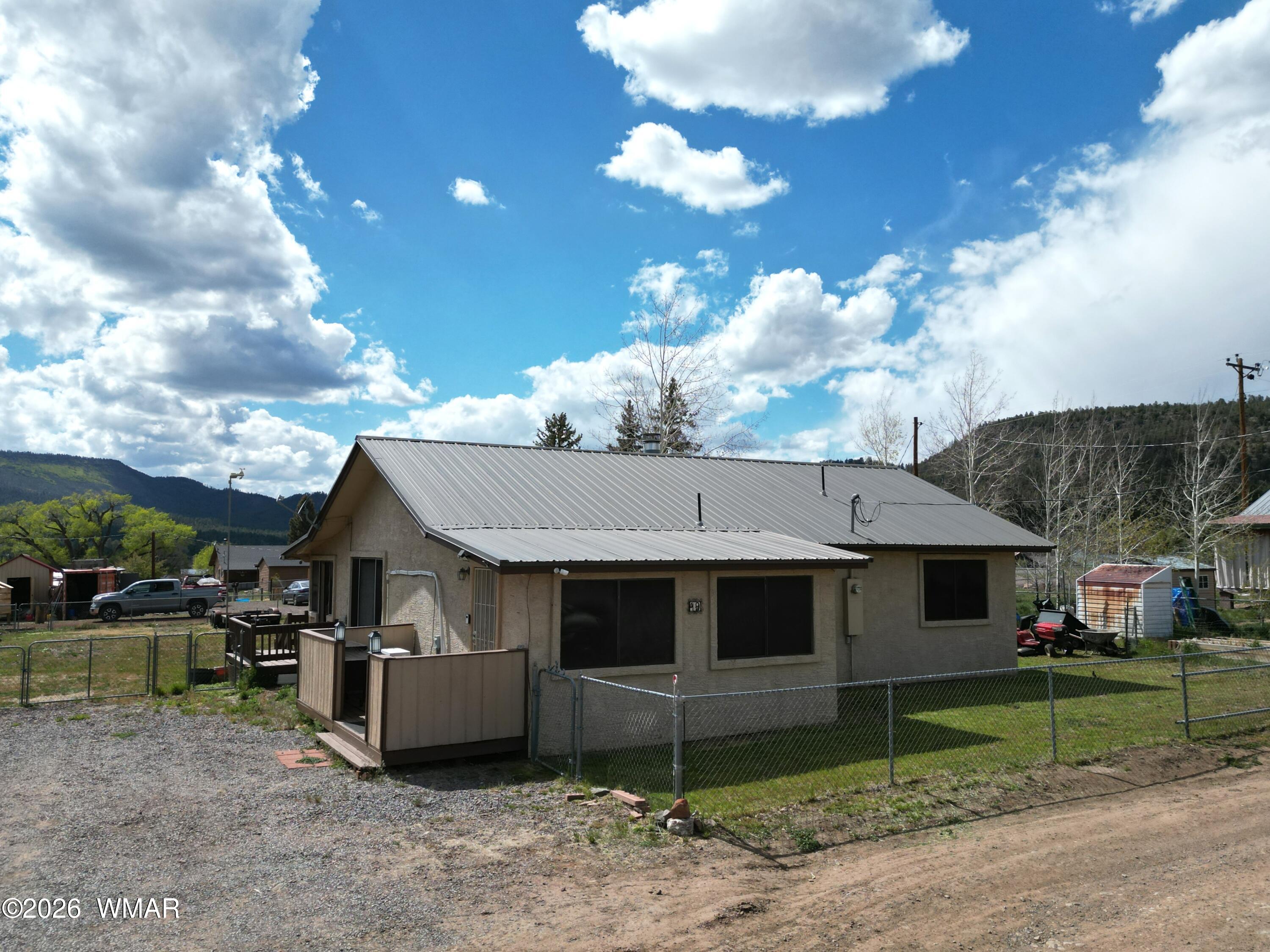 19 County Road Alpine, AZ 85920 - Photo 2 of 27 a view of a house next to a yard