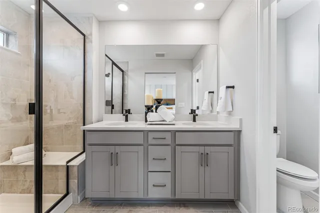 a bathroom with a double vanity sink and a mirror