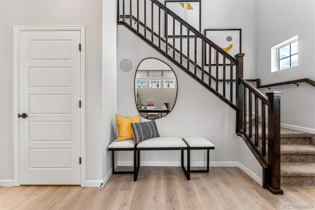 a kitchen with stainless steel appliances granite countertop a refrigerator a oven a stove a sink dishwasher and a dining table with wooden floor