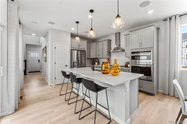 an open kitchen with a sink and breakfast area