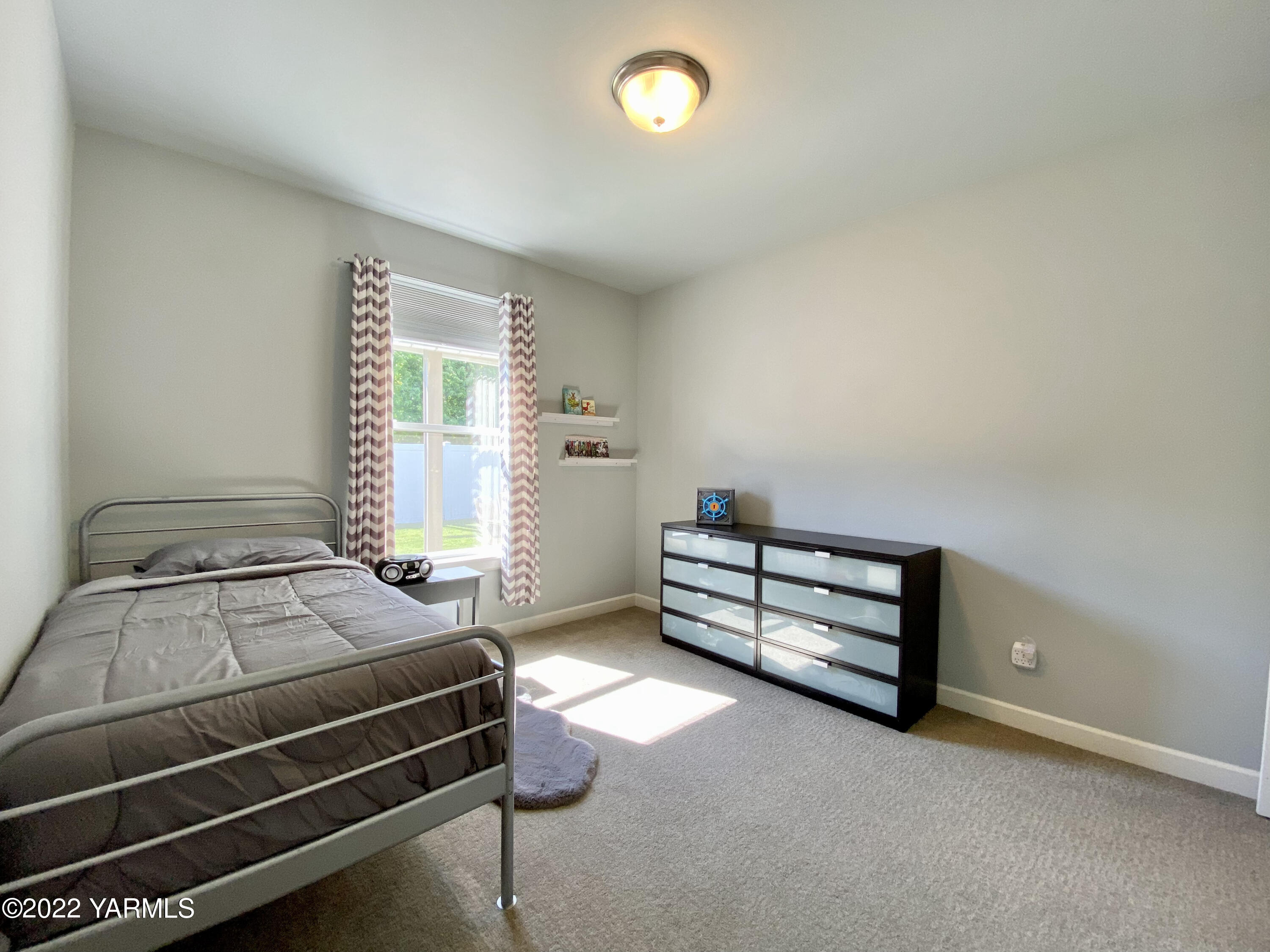 2110 Ruby Way Yakima, WA 98903 - Photo 14 of 36 a bedroom with a bed and a window