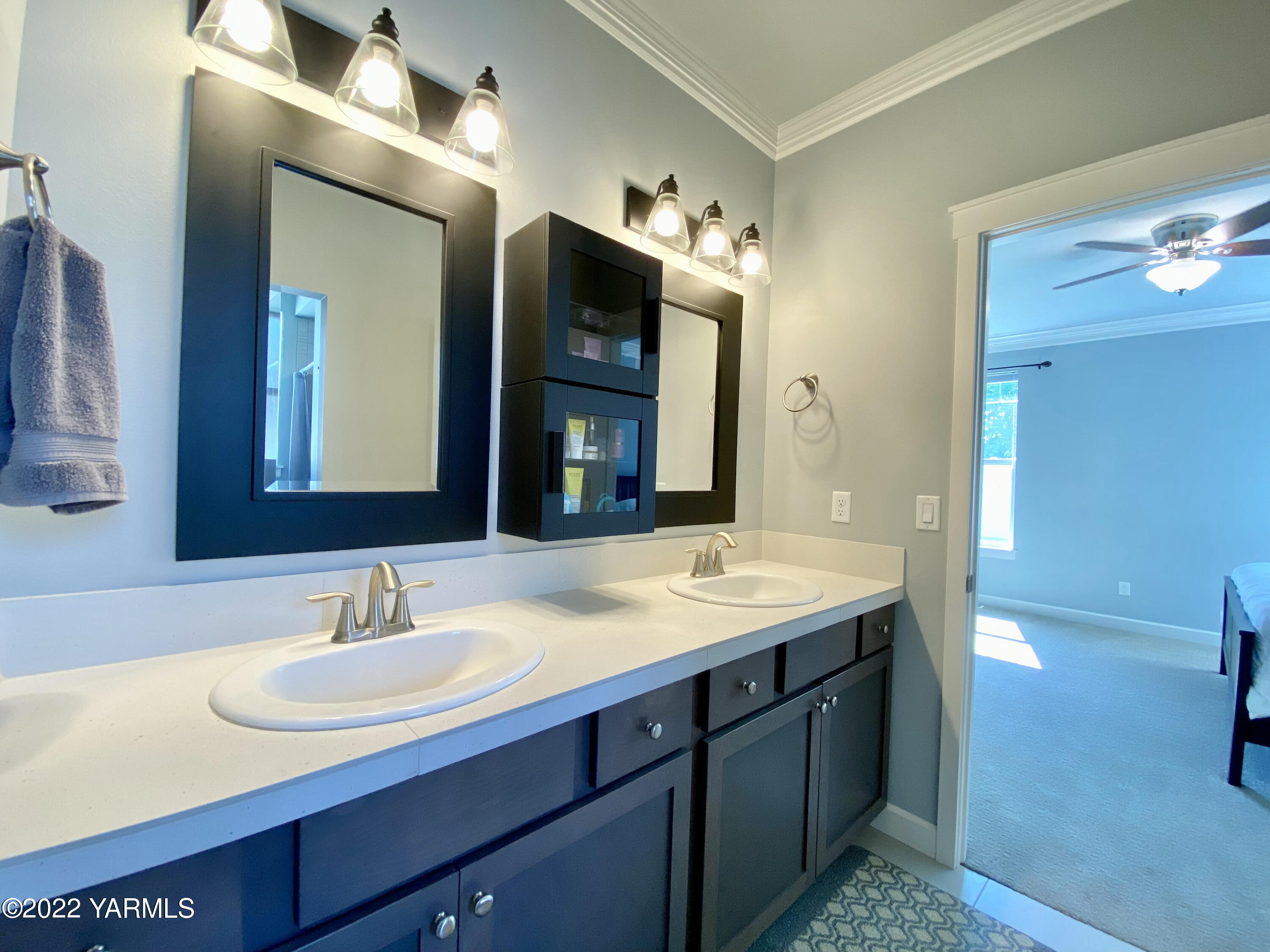 2110 Ruby Way Yakima, WA 98903 - Photo 34 of 36 a bathroom with a sink double vanity and a mirror