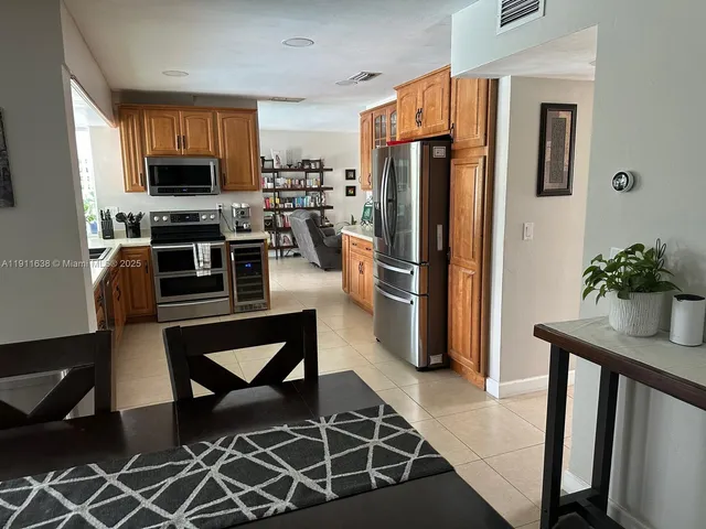 a kitchen with stainless steel appliances granite countertop a stove and a microwave