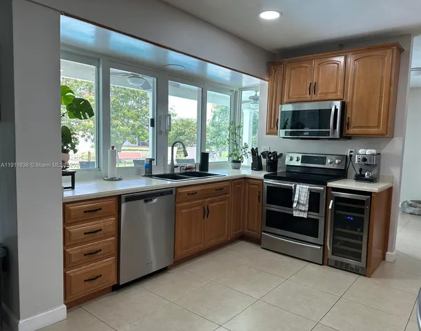 a kitchen with stainless steel appliances granite countertop a refrigerator stove and microwave