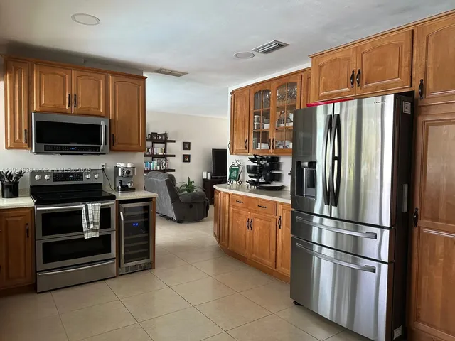 a kitchen with sink a counter space and cabinets