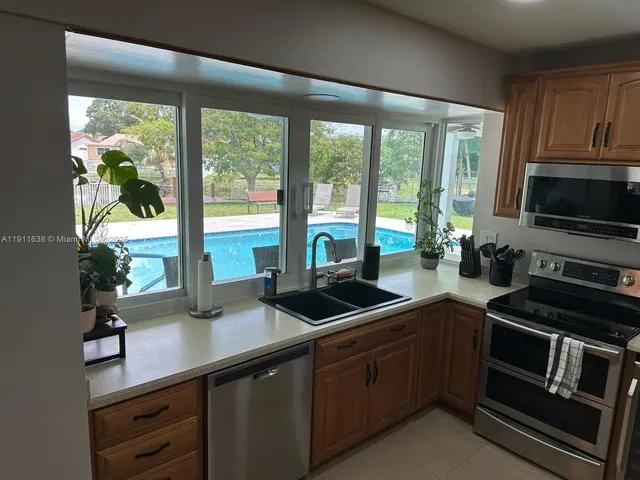 a kitchen with a sink and appliances