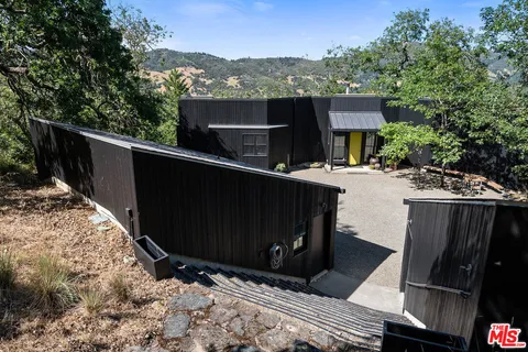 a living room with furniture next to a large window