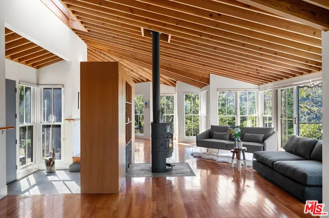 a kitchen with stainless steel appliances granite countertop a stove and a wooden floors