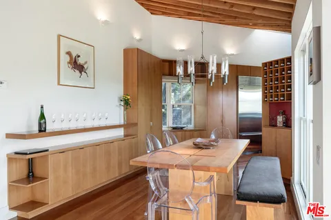 a bedroom with a bed and a large window with outer view