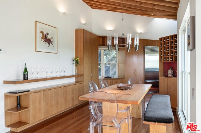 a bedroom with a bed and a large window with outer view