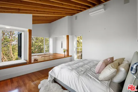 a living room with furniture a window and a flat screen tv