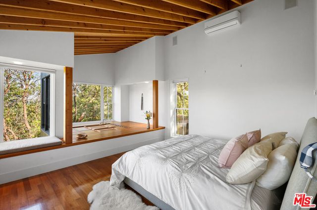 a living room with furniture a window and a flat screen tv