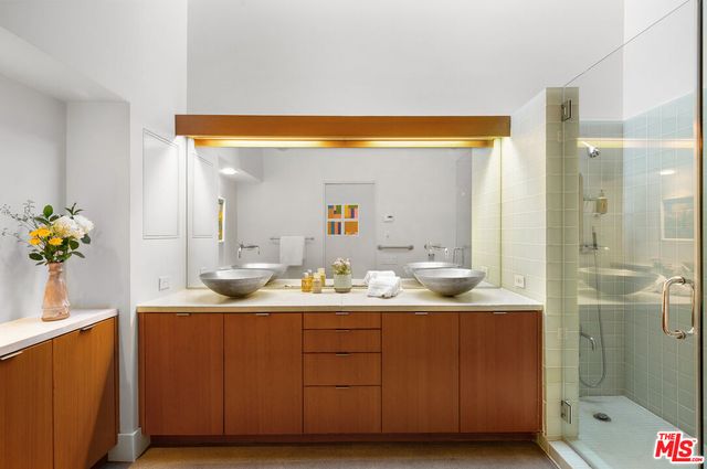 a bathroom with a sink vanity mirror and toilet