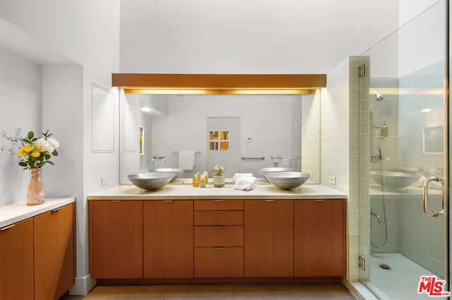 a bathroom with a sink vanity mirror and toilet