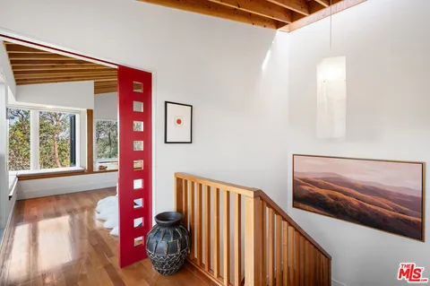 a view of a balcony with chair and the floor to ceiling window
