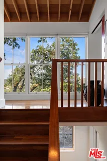 a living room with furniture large windows and a flat screen tv