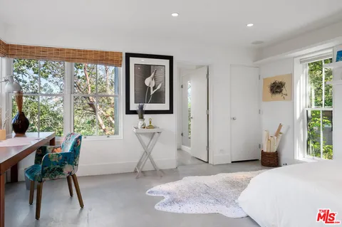 a living room with furniture flat screen tv and wooden floor