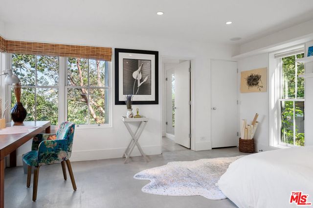 a living room with furniture flat screen tv and wooden floor