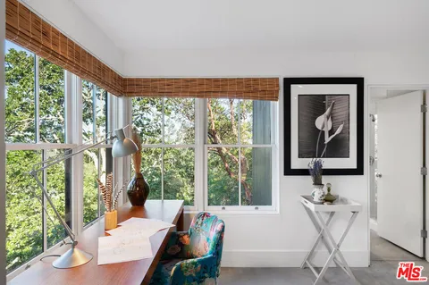 a view of balcony with wooden floor and fence