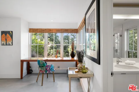 a view of bathroom with a toilet a sink and a mirror