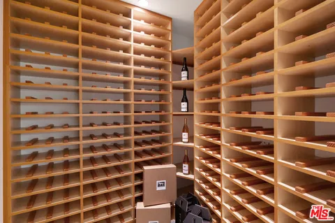 a view of a patio with table and chairs under an umbrella