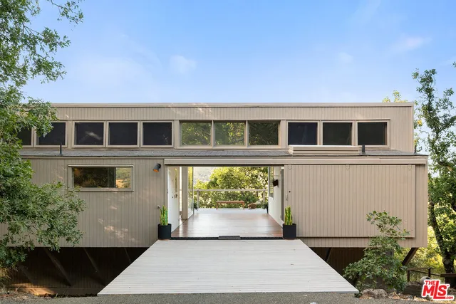 a view of a patio with couches table and chairs and potted plants