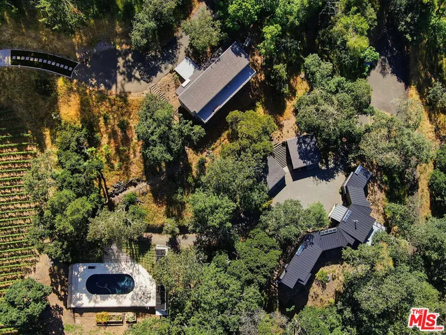 an aerial view of a house with a yard and garden