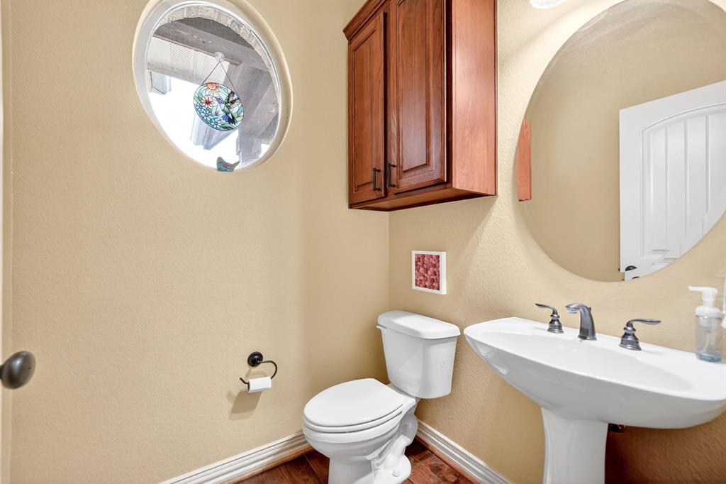 1399 Canyon Lake Road Wills Point, TX 75169 - Photo 23 of 37 a bathroom with a toilet a sink and mirror
