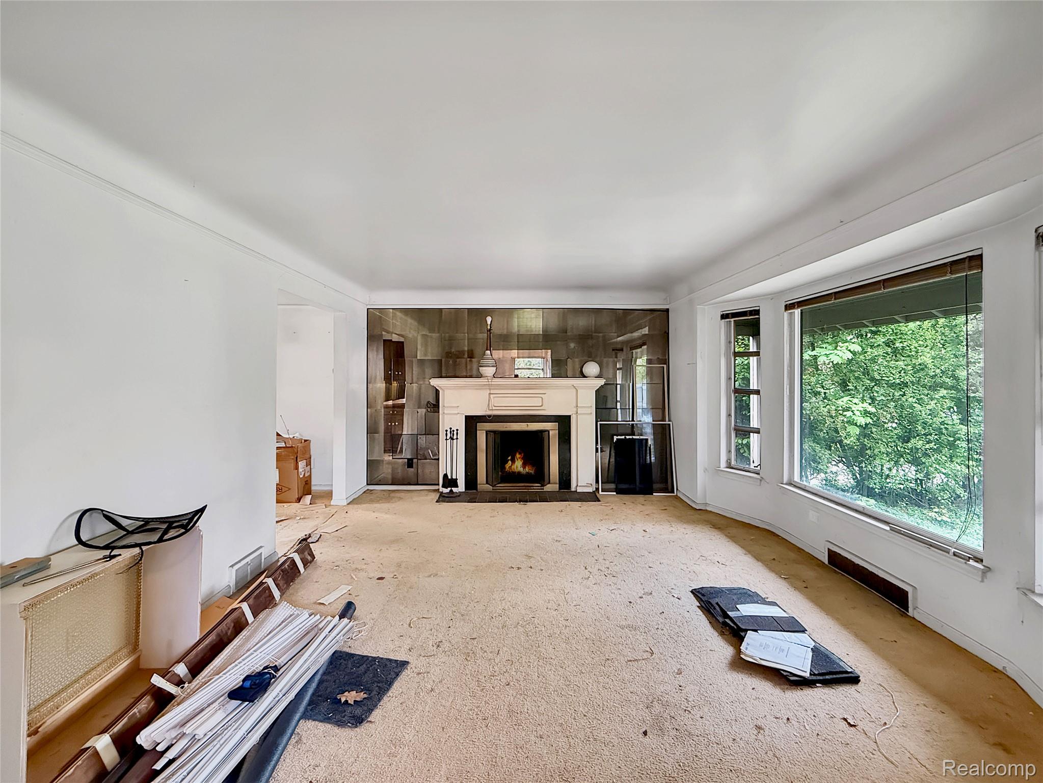 Unfurnished living room with a fireplace with flush hearth
