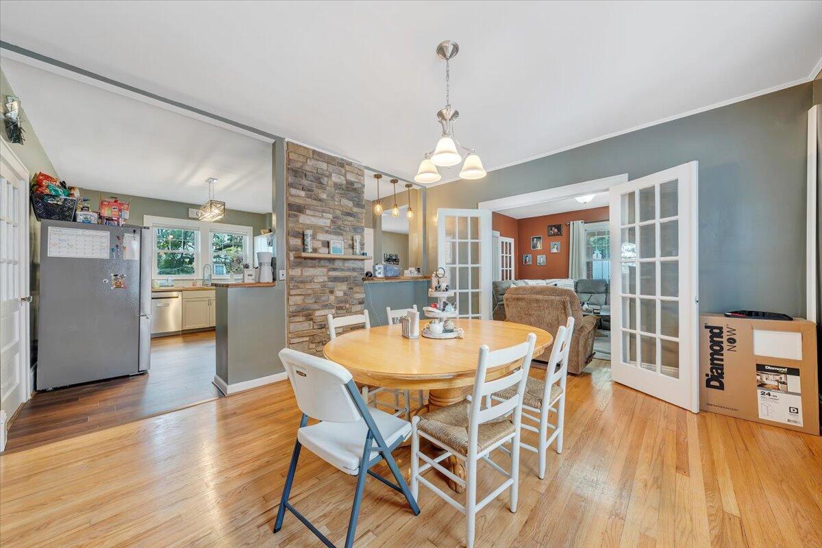 528 Riverland Road Southeast Roanoke, VA 24014 - Photo 14 of 42 a dining room with furniture a chandelier and wooden floor