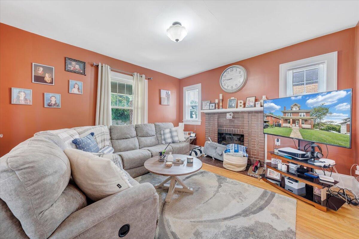 528 Riverland Road Southeast Roanoke, VA 24014 - Photo 18 of 42 a living room with fireplace furniture and a large window