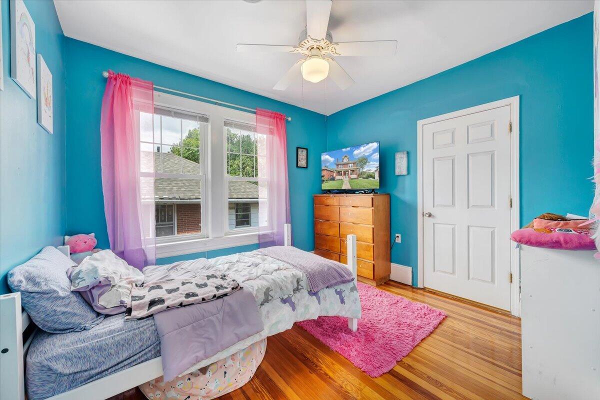 528 Riverland Road Southeast Roanoke, VA 24014 - Photo 25 of 42 a bedroom with a bed and a chandelier
