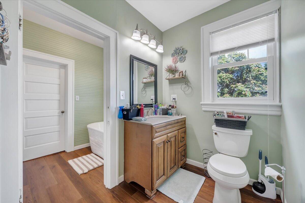 528 Riverland Road Southeast Roanoke, VA 24014 - Photo 28 of 42 a living room with a toilet a sink and a large mirror