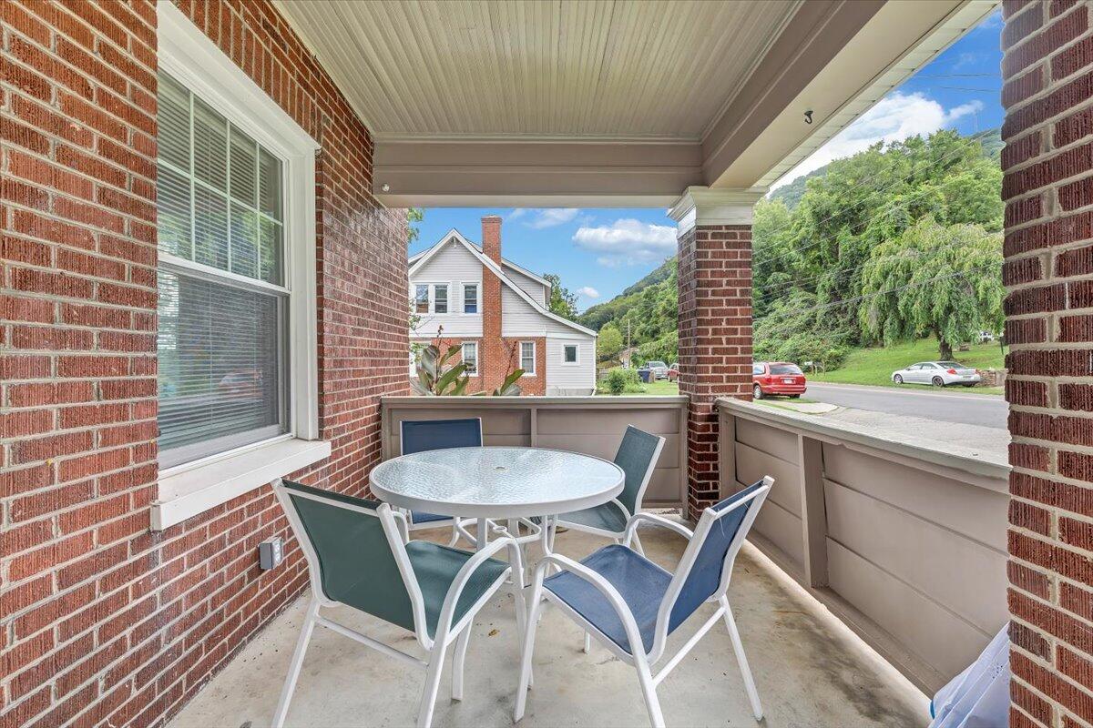 528 Riverland Road Southeast Roanoke, VA 24014 - Photo 35 of 42 a view of a patio with table and chairs and wooden floor