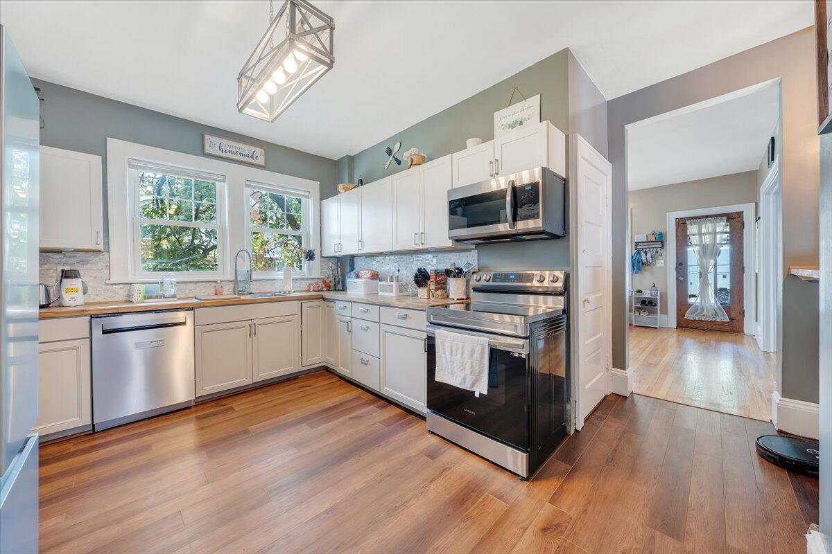 528 Riverland Road Southeast Roanoke, VA 24014 - Photo 7 of 42 a kitchen with stainless steel appliances white cabinets a sink and a stove