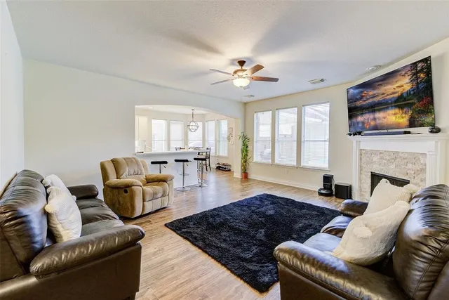 a living room with furniture flat screen tv and a fireplace