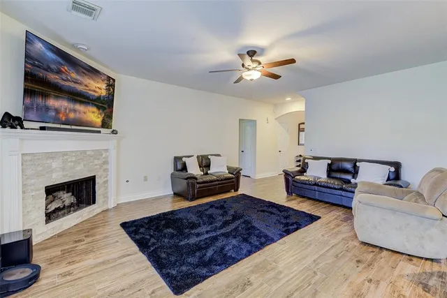 a living room with furniture fireplace and flat screen tv