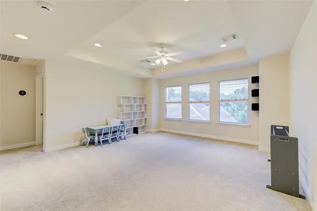 a view of a livingroom with furniture and a ceiling fan