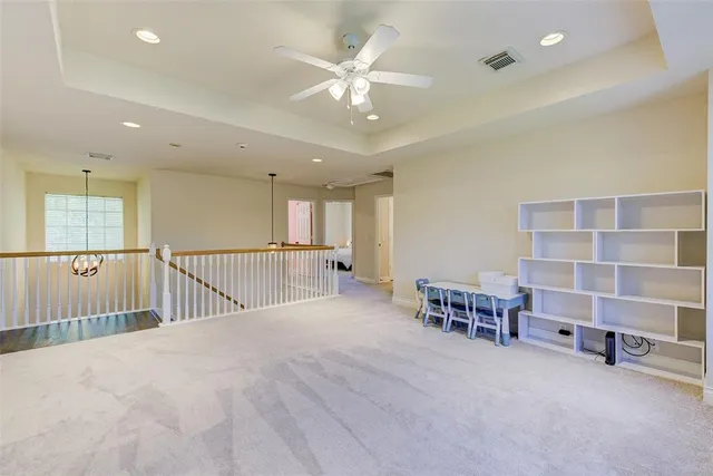 a bedroom with furniture and a chandelier fan