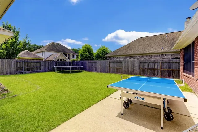 a view of a house with swimming pool and a yard